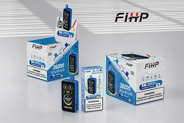 Several FiHP disposable vape devices and matching blue-and-white retail boxes labeled “Double Flavor” and “36000 puffs” (Cherry Ice / Blueberry Raspberry) arranged on a reflective tabletop with a large FiHP logo on the wall behind them.