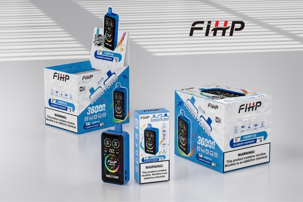 Several FiHP disposable vape devices and matching blue-and-white retail boxes labeled “Double Flavor” and “36000 puffs” (Cherry Ice / Blueberry Raspberry) arranged on a reflective tabletop with a large FiHP logo on the wall behind them.