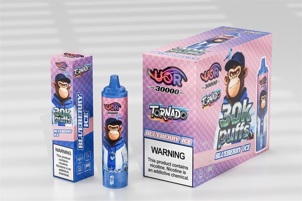 Pink and purple checkered display box, matching smaller box and a blue disposable vape device labeled '30k puffs Blueberry Ice' with a cartoon monkey mascot and a prominent nicotine warning.