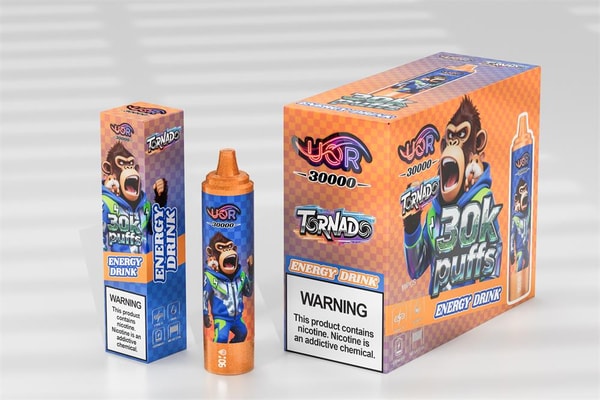Disposable vape device and two matching boxes for 'Tornado' energy-drink flavor in bright orange and blue, featuring a shouting cartoon monkey, '30K puffs' branding and a visible nicotine warning label.