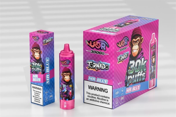 Bright pink and purple vaping box and matching disposable device labeled "30K puffs Mr Blue," featuring a cartoon monkey in a beanie, brand name "Tornado," and a prominent nicotine warning label.