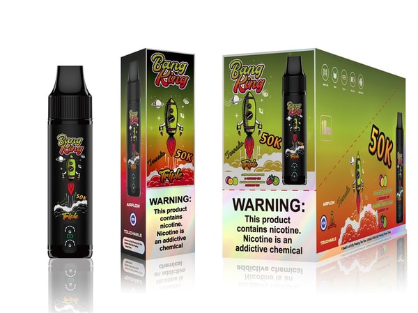 Black disposable vape device shown alongside its matching green-to-orange retail box and larger display carton, all featuring a cartoon green rocket, 'Bang Ring 50K Triple' branding, flavor icons, airflow/touchable symbols and a prominent nicotine warning label.
