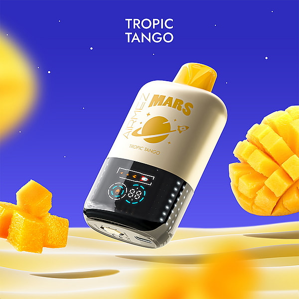 Cream-and-yellow Mars Tropic Tango disposable vape device with a black digital display and planet logo floating above rippled sand, surrounded by diced mango cubes and a sliced mango against a bright blue background.