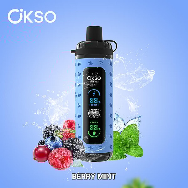 Blue ÖKSO Shishai bottle with a black cap and vertical LED display showing battery icons, set against a light blue background with water splashes, surrounded by mixed berries and mint leaves and the label 'BERRY MINT' below.