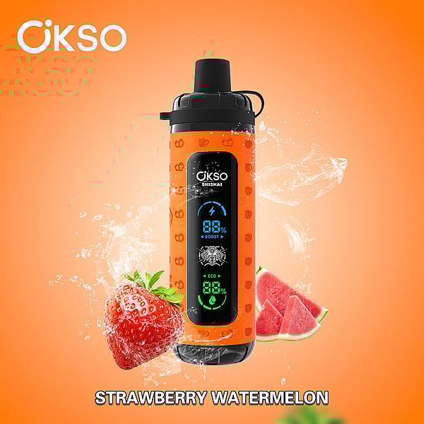 Orange ÖKSO portable shisha device with black cap and vertical digital display, water splashing behind it and a strawberry and watermelon slices in front on an orange background labeled Strawberry Watermelon