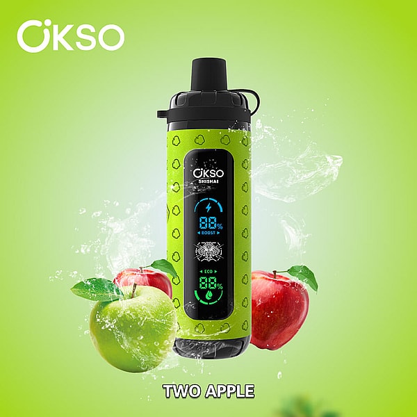 Green OKSO Shishai cylindrical vape device with a black mouthpiece and central blue digital display, set against a lime-green background with a red and a green apple and water splashes, captioned "TWO APPLE".
