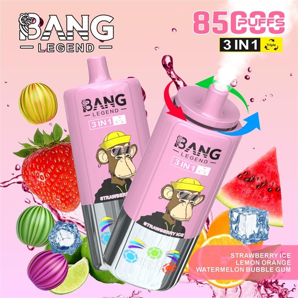 Two pink Bang Legend 3-in-1 disposable vape devices featuring a cartoon monkey in a yellow hat, surrounded by strawberries, watermelon, lime and orange slices, ice cubes and colorful candy spheres with liquid splashes, alongside a prominent "85 puffs" badge and flavor list (Strawberry Ice, Lemon Orange, Watermelon, Bubble Gum).