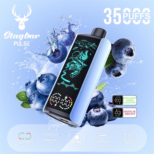 Light-blue Stagbar PULSE disposable vape with a black digital display showing teal graphics, tilted amid splashing blueberries and water droplets, with '35 PUFFS' text and small icons indicating mesh coil, 30 mL capacity, Type‑C recharge and adjustable airflow.