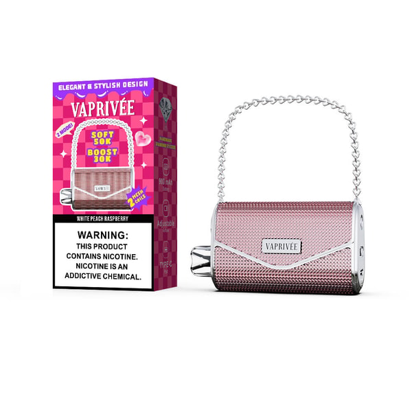 Pink textured VAPRIVÉE portable vape with silver trim and heart-link chain handle beside a matching pink product box labeled VAPRIVÉE and White Peach Raspberry, showing a nicotine warning label.