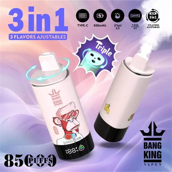 Two pastel pink cylindrical vape devices—one with a cartoon monkey decal and the other with fruit icons—one emitting vapor, shown on a purple-pink background with labels and icons reading 3 in 1, 3 flavors adjustable, Type-C, 600mAh, 21ml x3, 85 puffs, and the Bang King Vapen logo.
